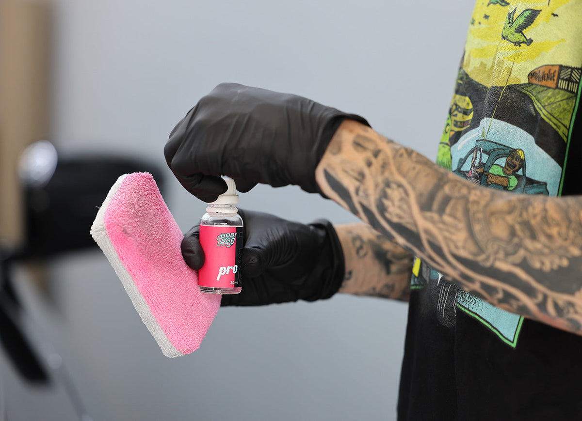 Detailer applying Undrdog Pro ceramic coating with a foam applicator