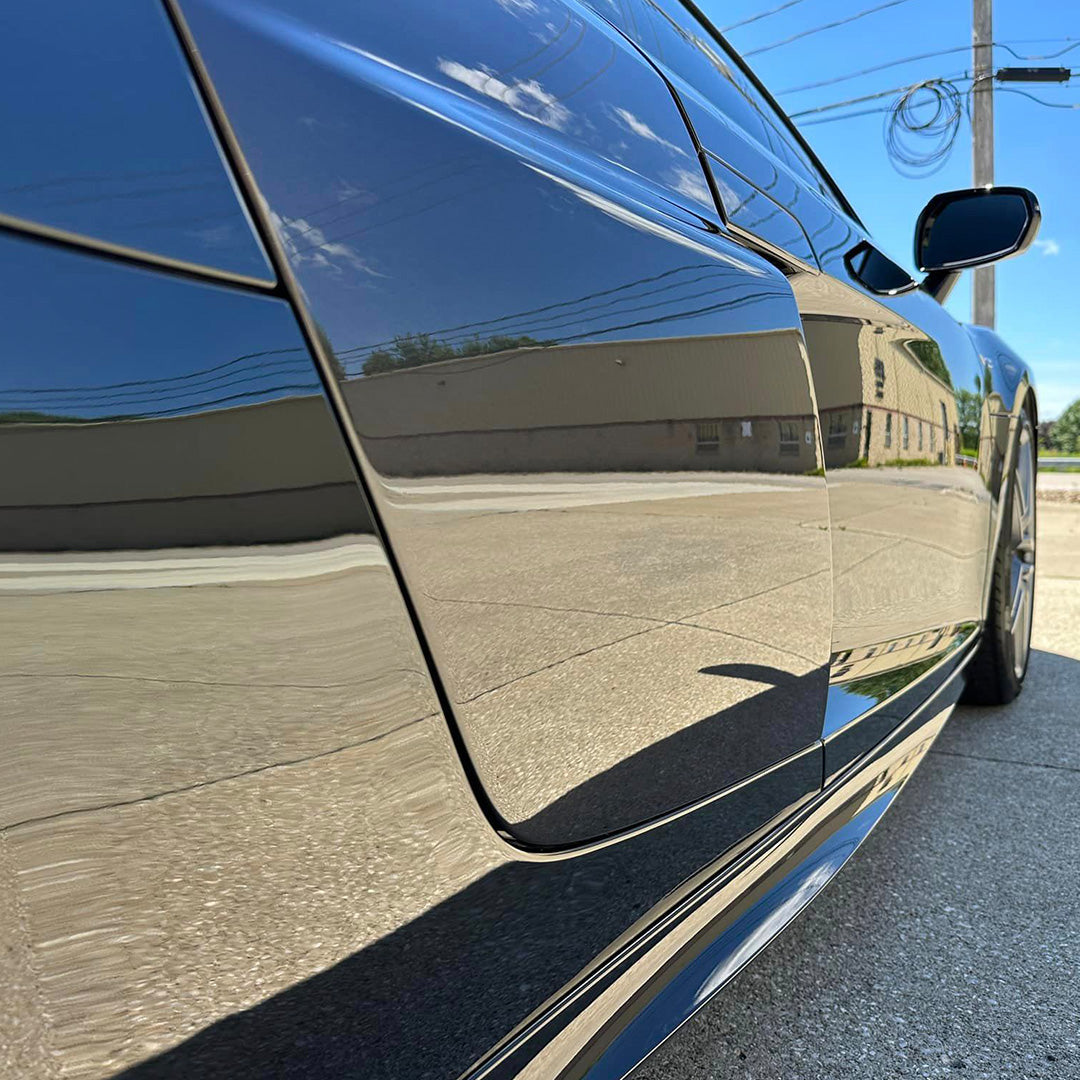 Reflective dark vehicle door and side panels in an official Undrdog photograph
