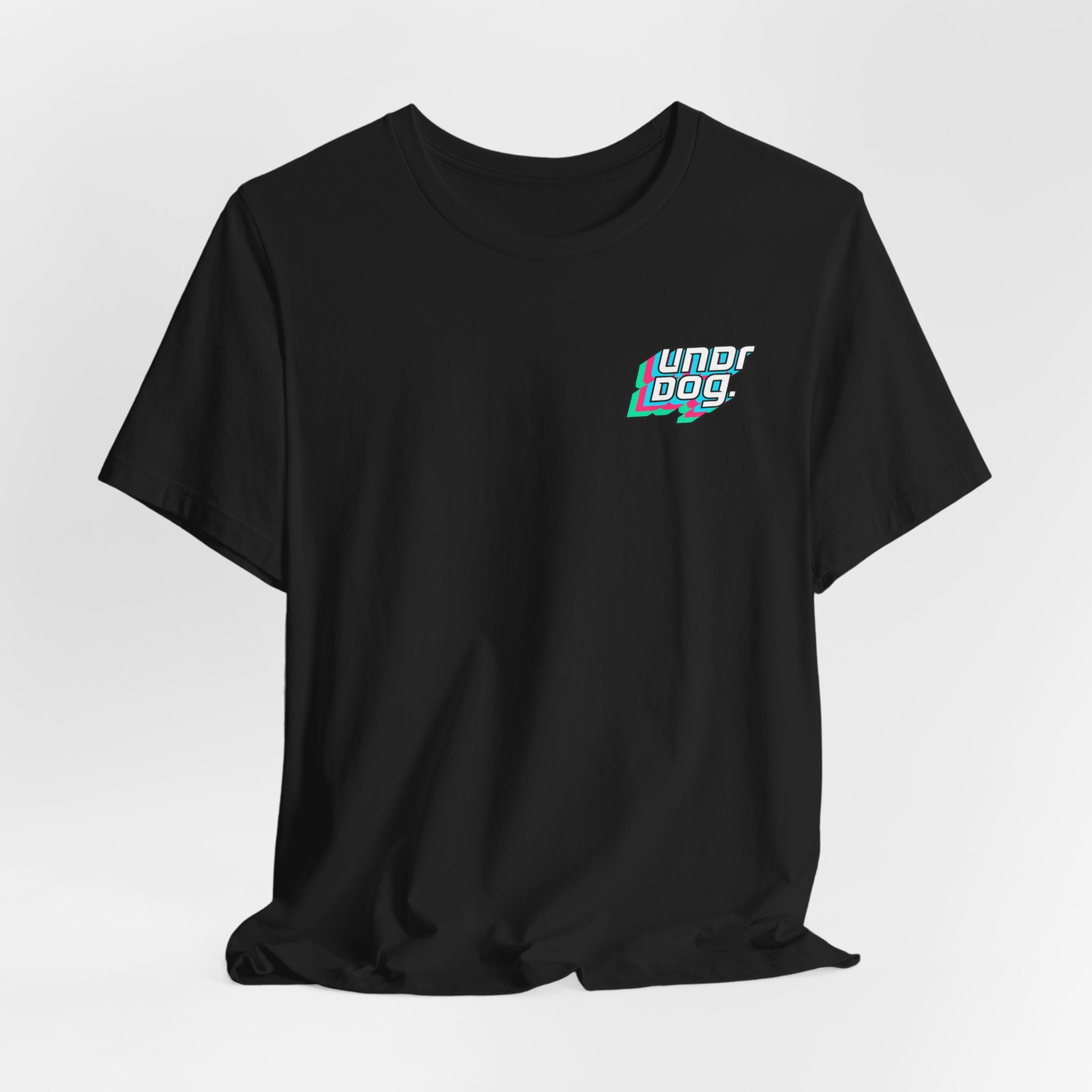A black Unisex Jersey Short Sleeve Tee from Printify, made with premium Airlume cotton and based on the Bella Canvas 3001, displays the phrase "undr dog." in bold white text with blue and red shadow accents on the upper left chest. The t-shirt is shown against a plain white background.