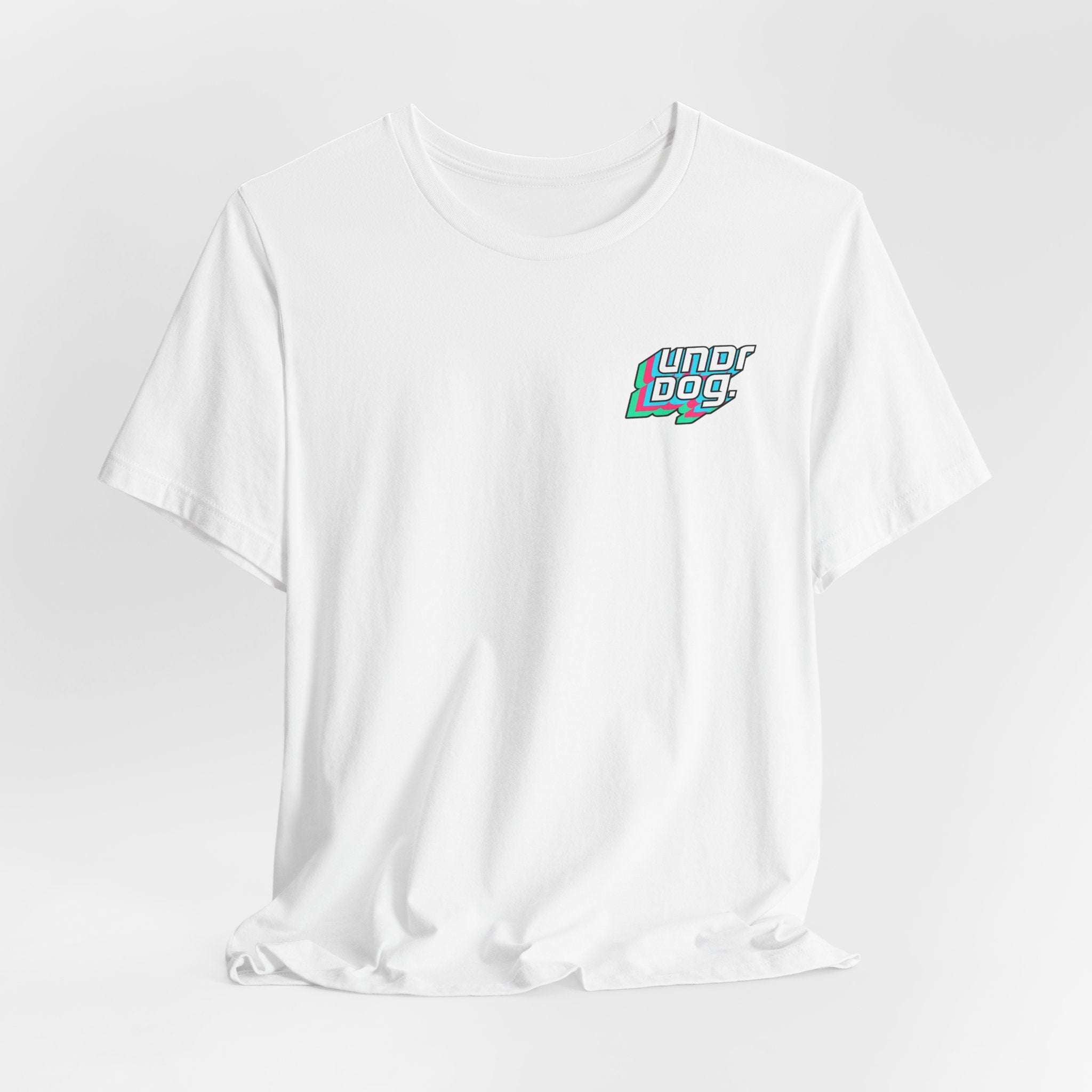 A white Printify Unisex Jersey Short Sleeve Tee features the word "underdog" in colorful, stylized letters on the upper left chest. Made from soft Airlume combed cotton, this shirt is showcased against a light, neutral background.