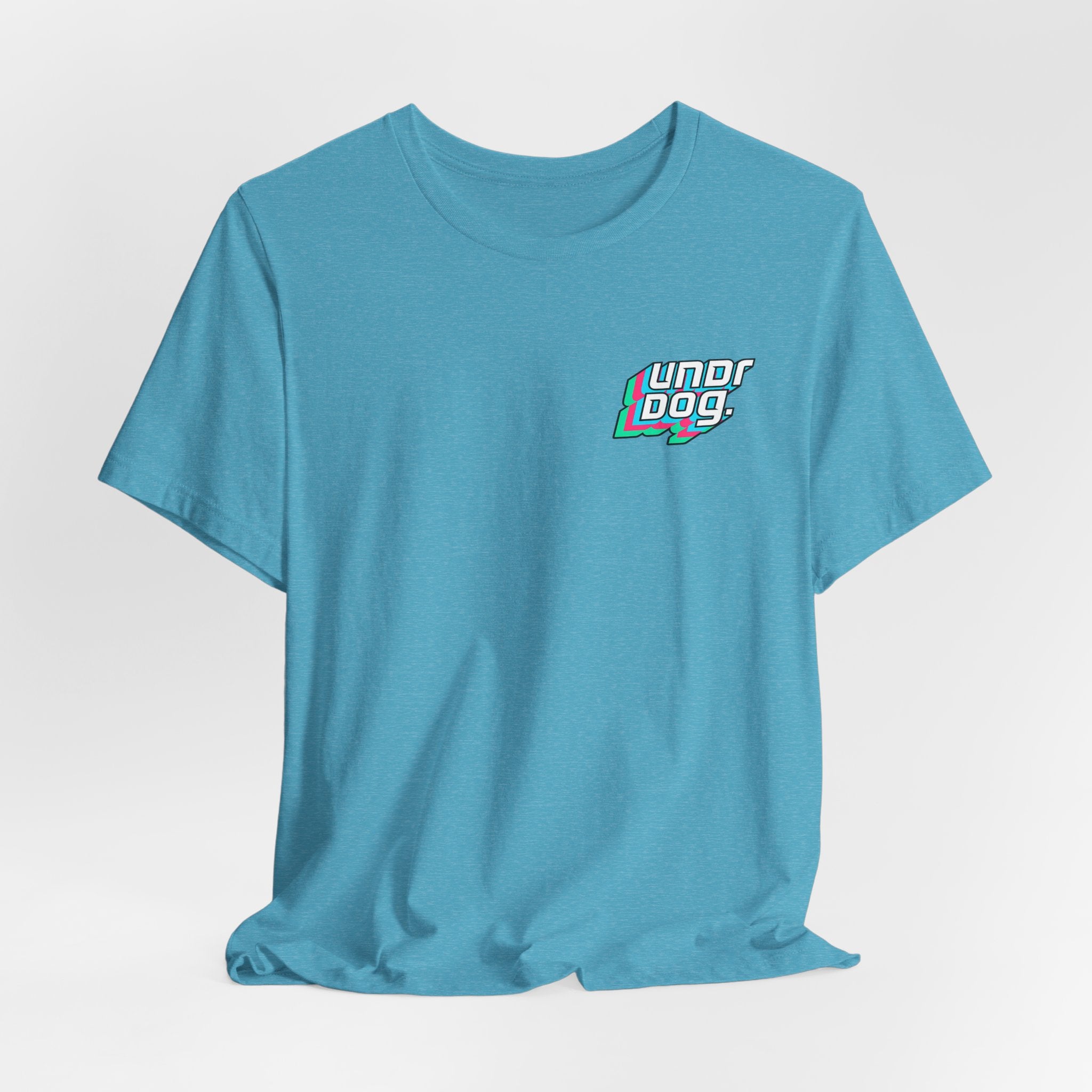 The See Yourself In It Retro Sportscar Tee by Printify is shown on a white background, featuring bold, colorful "Underdog." lettering on the left chest.