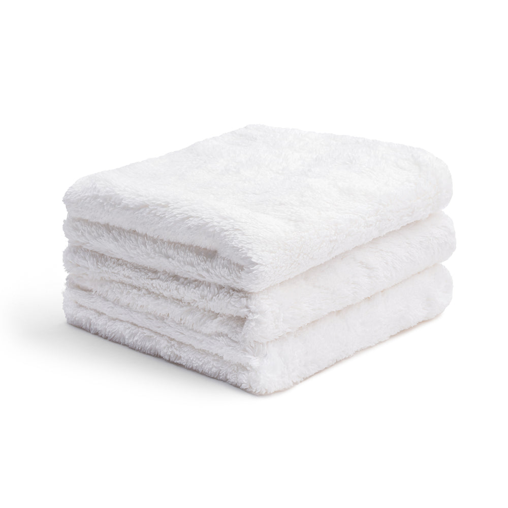 A neatly folded stack of three premium 400 gsm White Coating Towels by Undrdog Surface Products, featuring exquisite detailing, displayed on a plain white background.
