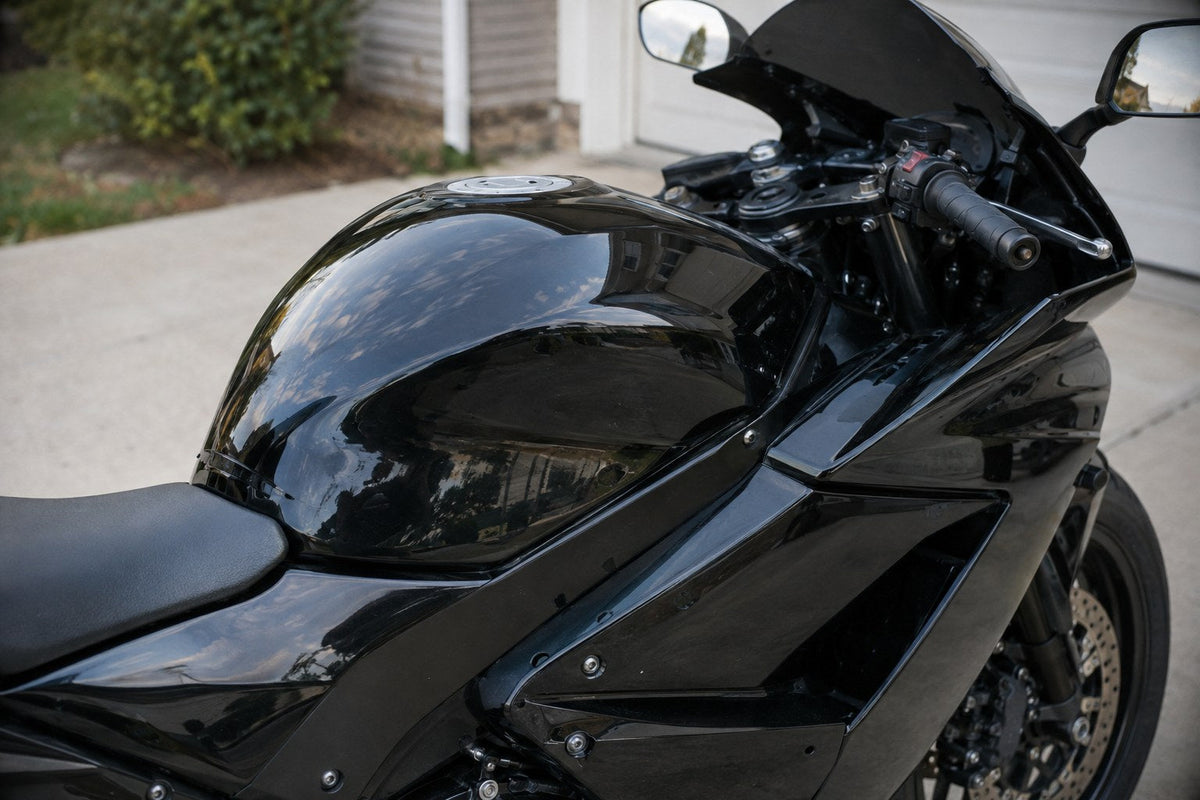 Glossy black sport motorcycle fuel tank and fairings after cleaning