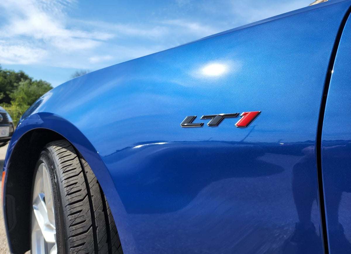 Water beading on a coated blue Chevrolet fender, a simple sign the coating is still active