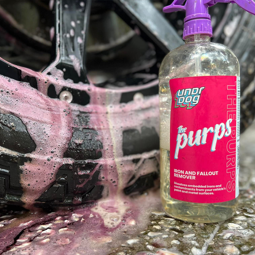The Purps bottle beside a wheel with purple runoff