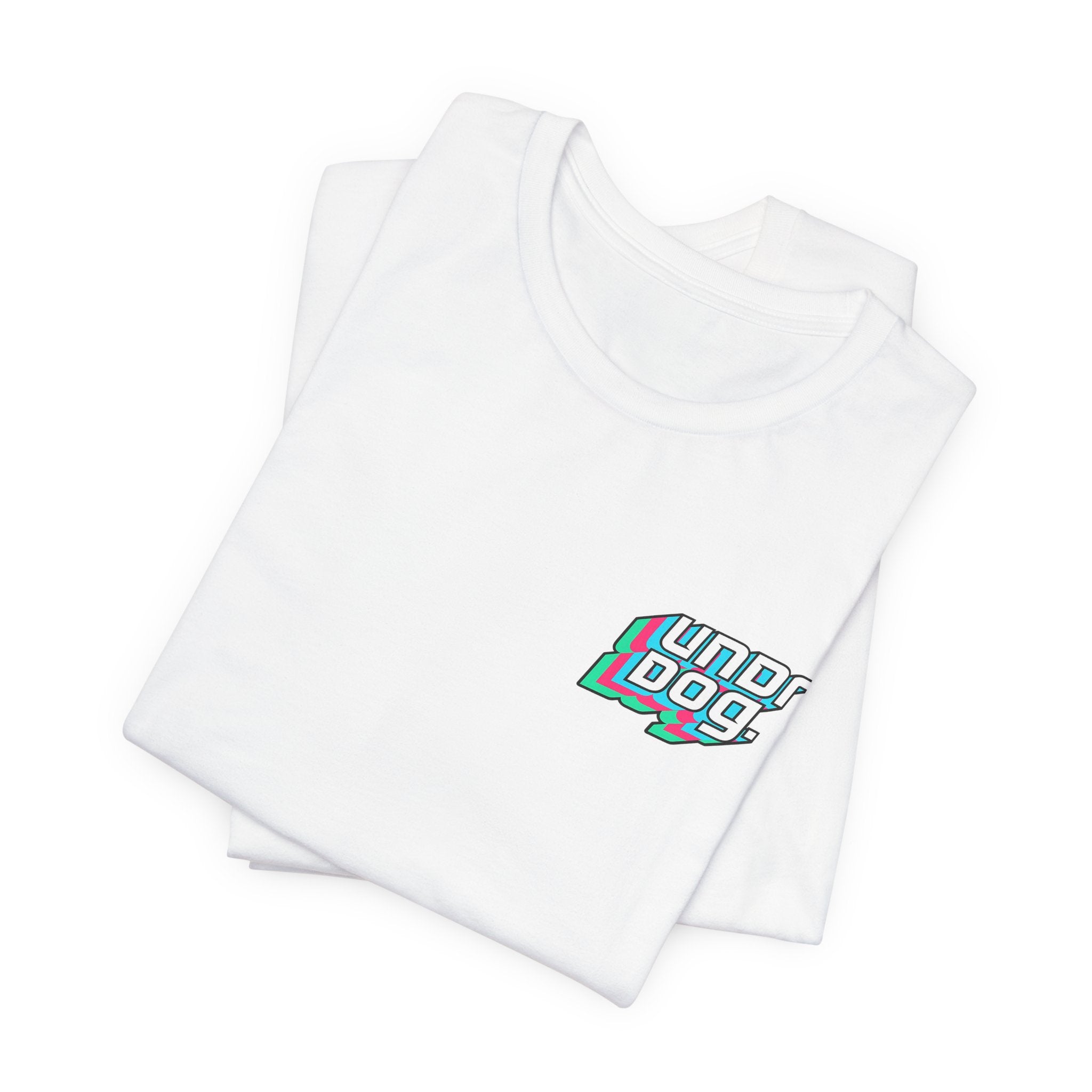 A neatly folded white See Yourself In It Retro Sportscar Tee by Printify, featuring "Underdogs" printed in stylized, colorful text on the left chest area.