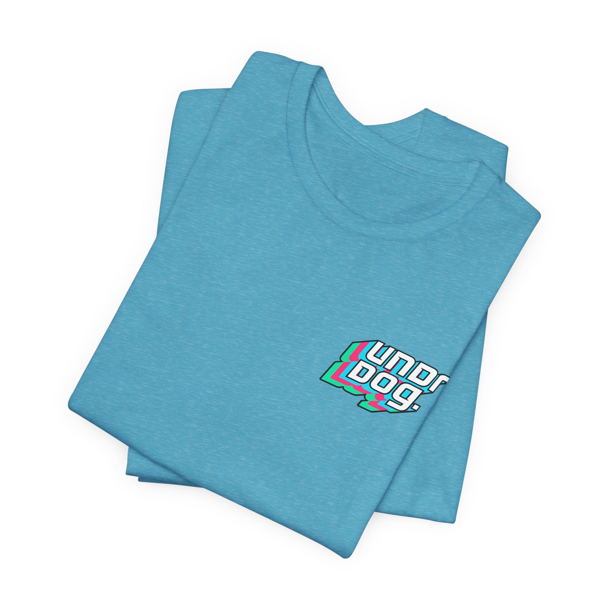 The Printify See Yourself In It Retro Sportscar Tee is a folded light blue shirt featuring "Underdogs!" in bold white, black, and green letters on the left chest.