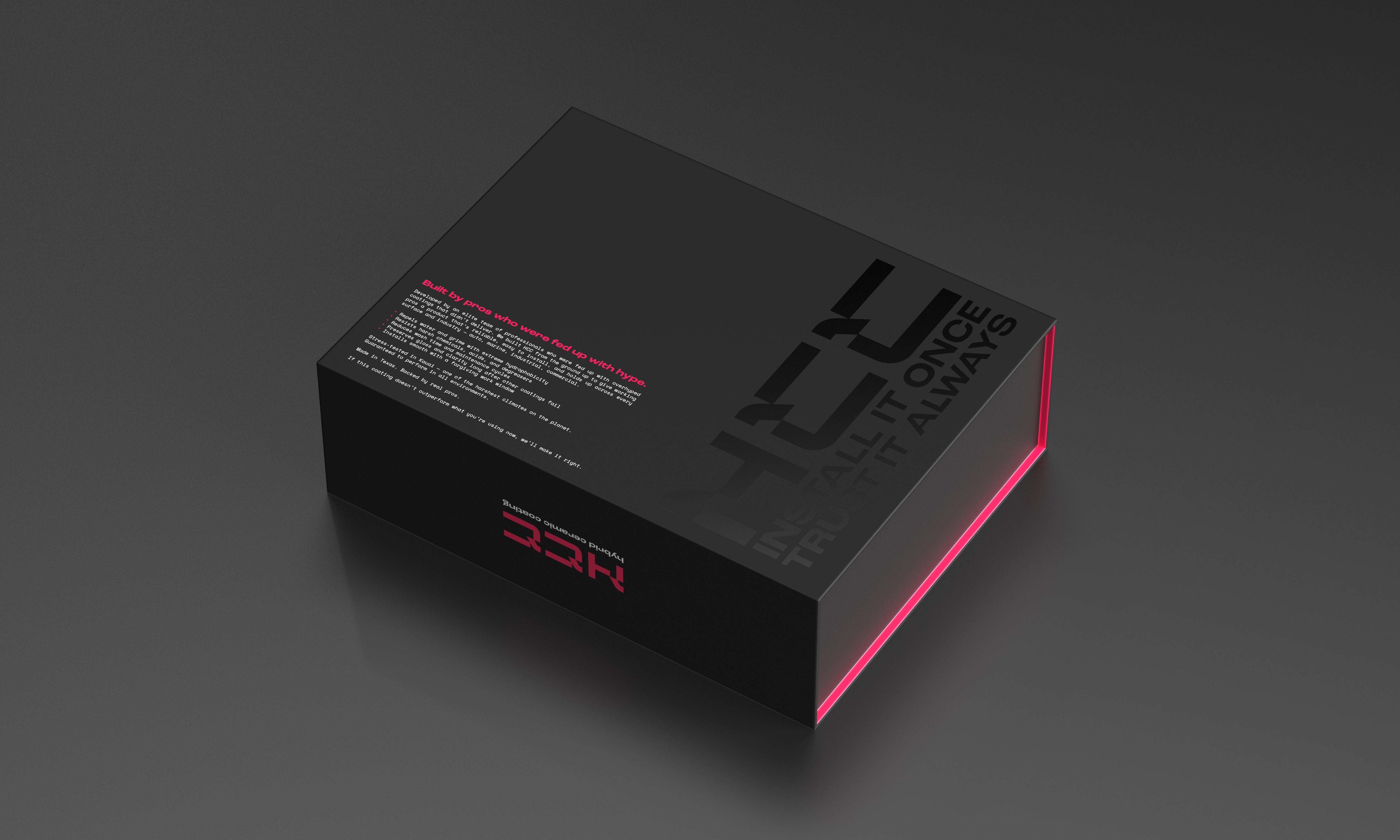 A sleek black box for Undrdog Surface Products’ HCC - Hybrid Ceramic Composite, with bold minimalist text reading "NEVER TROPHY ONCE TROPHY ALWAYS," sits on a dark surface accented by a faint pink glow along one edge.
